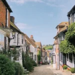 Historic cobblestone street with traditional half-timbered English houses