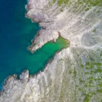 Aerial view of rocky coastline and turquoise water in Croatia
