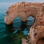 Dramatic golden cliffs along the Algarve coastline in Portugal at sunset