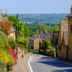 Picturesque Cotswold village street with stone houses in England