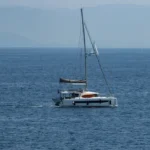 Sailing yacht on calm blue waters off the coast of Corfu, Greece