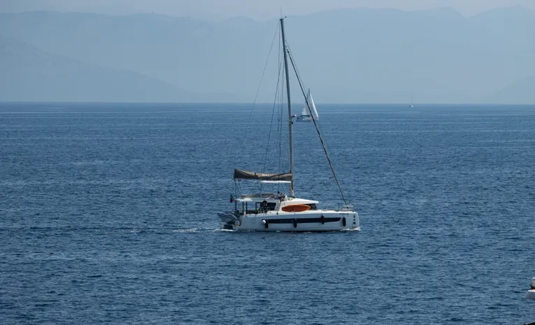 Sailing yacht on calm blue waters off the coast of Corfu, Greece