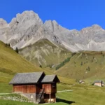 Traditional chalets set against the Dolomites mountains in Italy