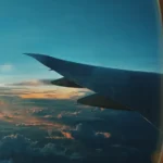 Dramatic sunset view through an airplane window during a long-haul flight
