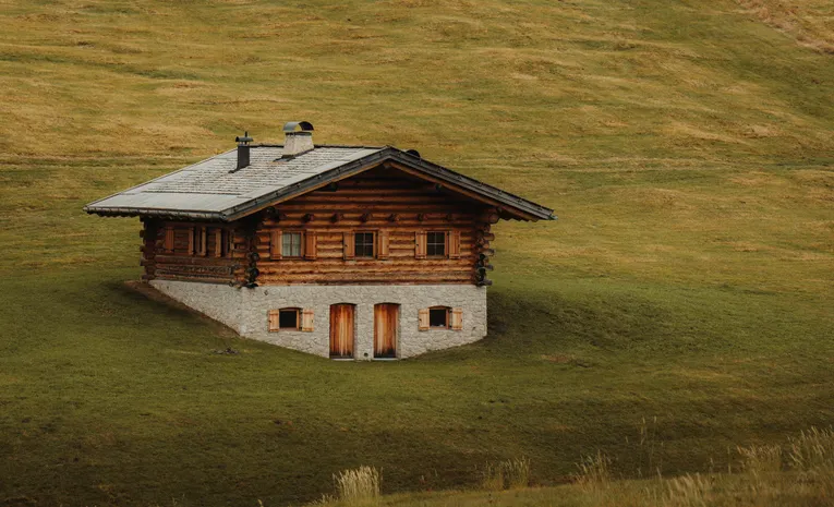Rustic chalet nestled in green countryside hills
