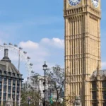 Big Ben and the London Eye on a sunny day beside the River Thames
