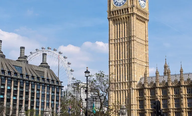 Big Ben and the London Eye on a sunny day beside the River Thames